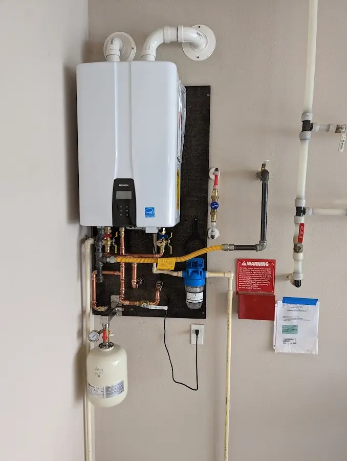 Professional plumber installing copper piping in a Boonville home